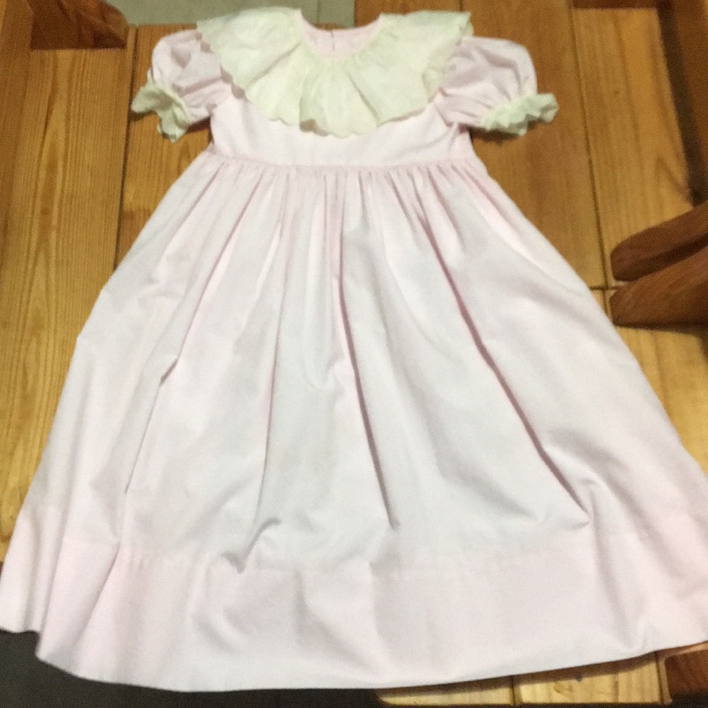Pink pleated dress with ruffled white sleeves